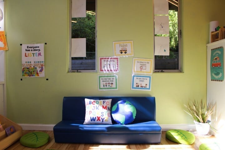 Inviting preschool reading nook with books and learning posters at Kids Konnect San Mateo Bunker Hill