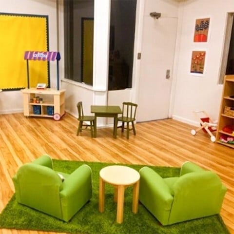Cozy preschool reading nook with child-sized furniture at Kids Konnect San Mateo