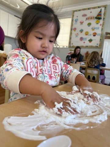 Toddler engaging in a foam sensory play activity at Kids Konnect preschool