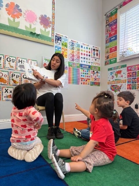 Teacher leading a preschool storytime and literacy activity at Kids Konnect classroom
